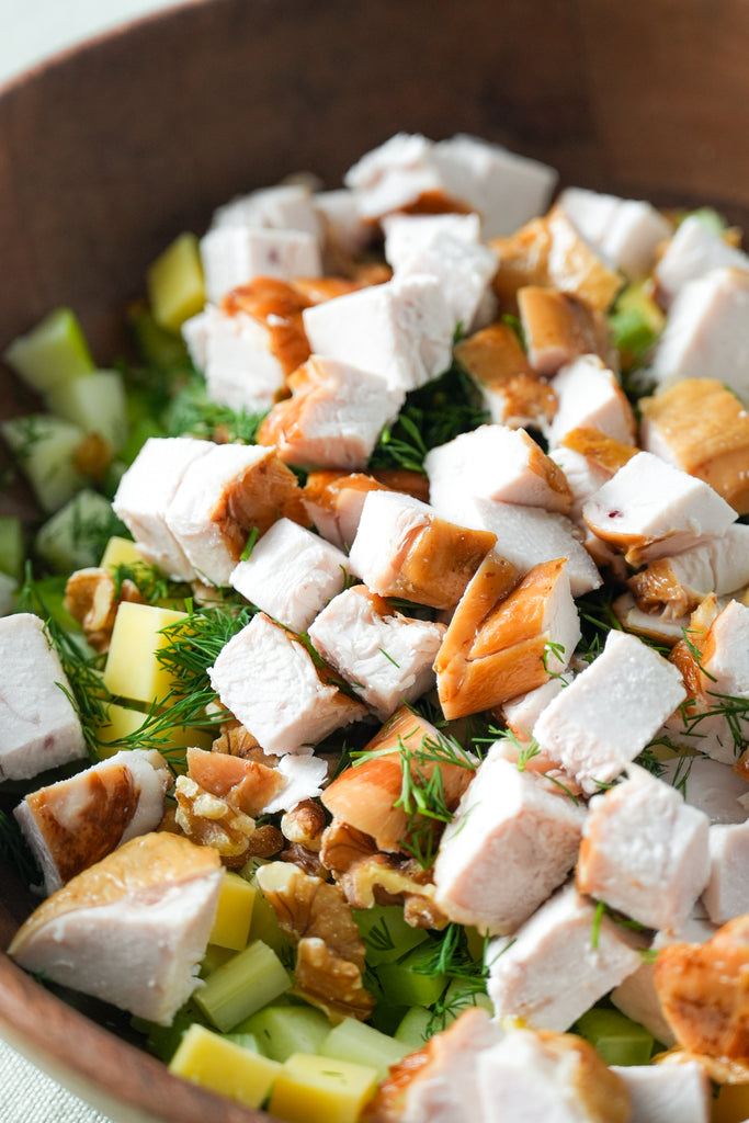 Juicy slices of The Lucky Pig’s free-range smoked chicken breast served on a fresh salad, showcasing tender texture and subtle smokiness.