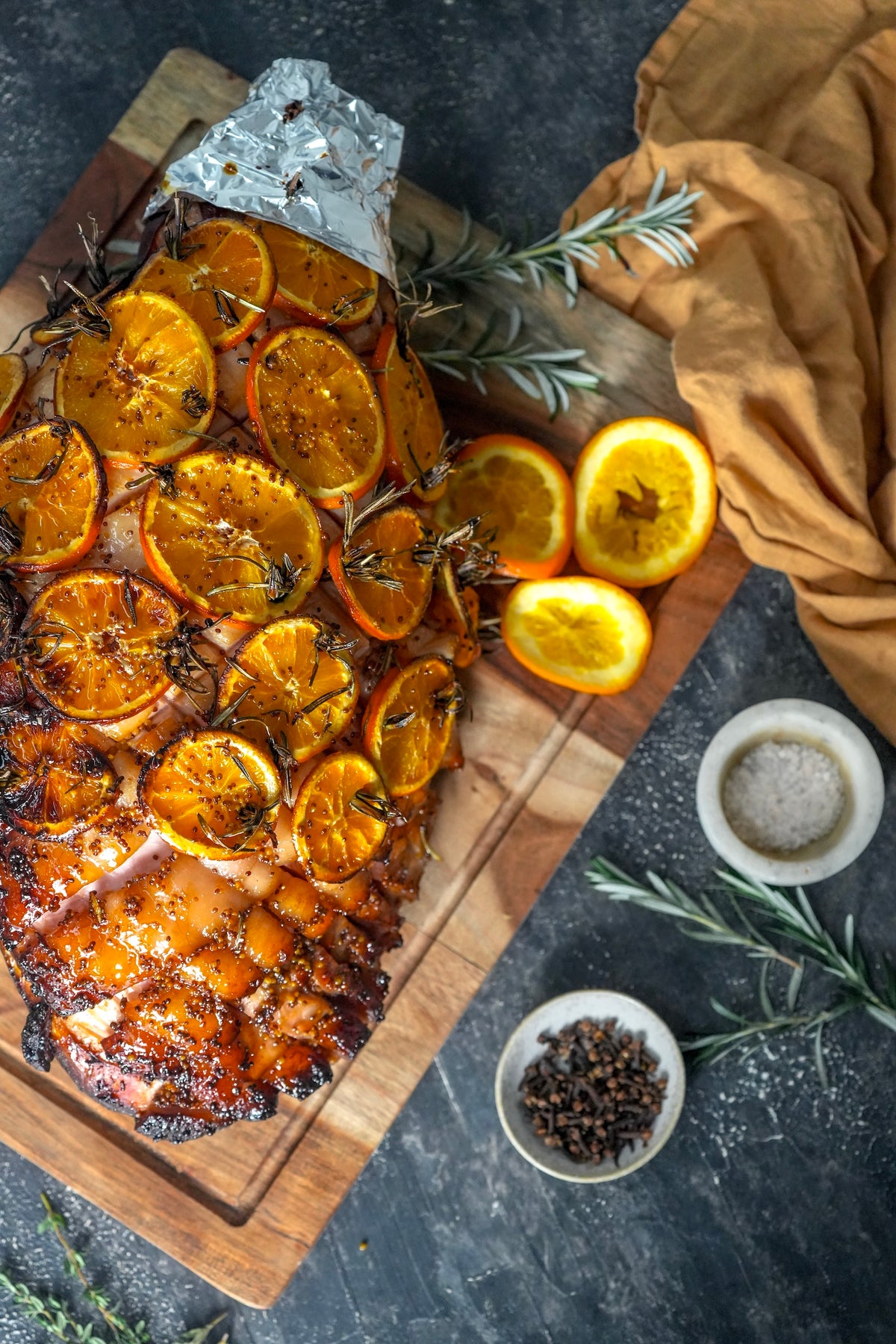 The Lucky Pig glazed Christmas ham with orange slices and rosemary